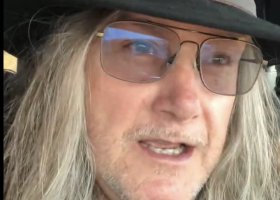 Man with long hair wearing a hat and glasses.