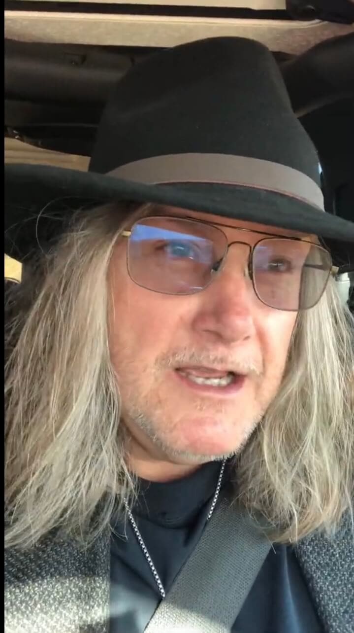Man wearing glasses and a hat