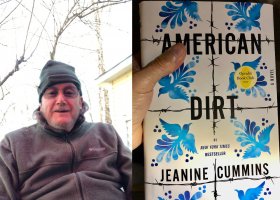 Man holding book "American Dirt" by Jeanine Cummins.