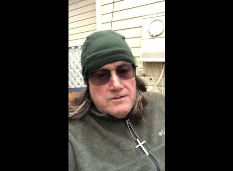 Individual in green hat and glasses