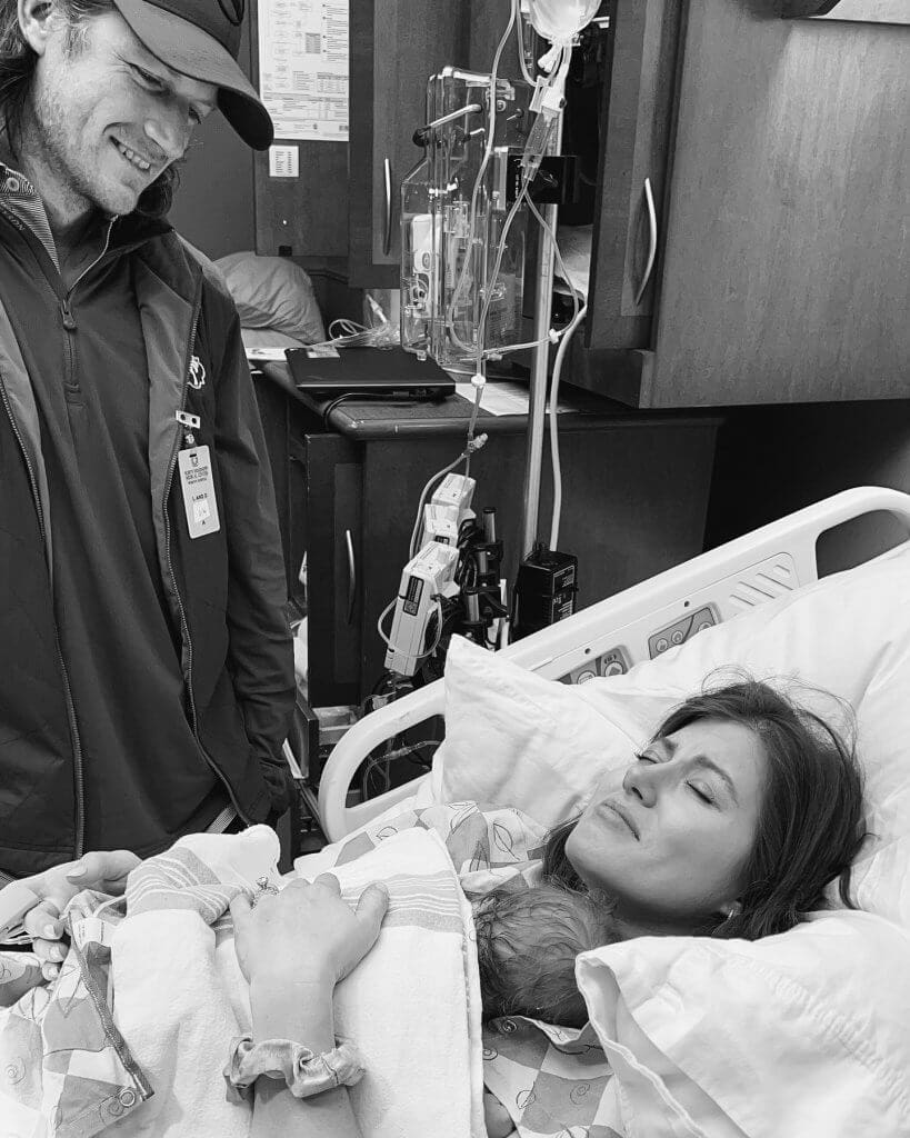 Mother holding baby in hospital bed
