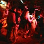 People dancing in a dimly lit club.