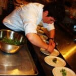 Chef Samantha Shelton plating her dish during FRENCH NIGHT MADIDI. Photo by Callie Riddell.