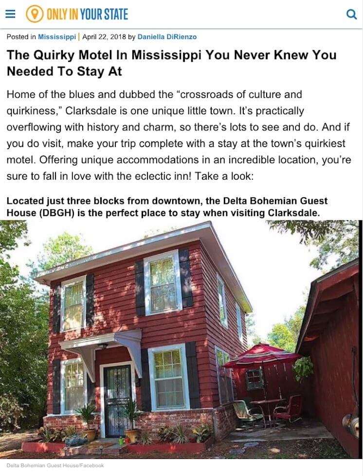 Charming red guest house with porch chairs