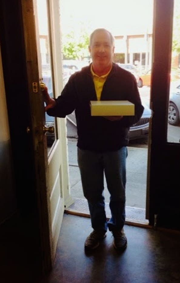 Baker Patton delivering one of his homemade cheesecakes.