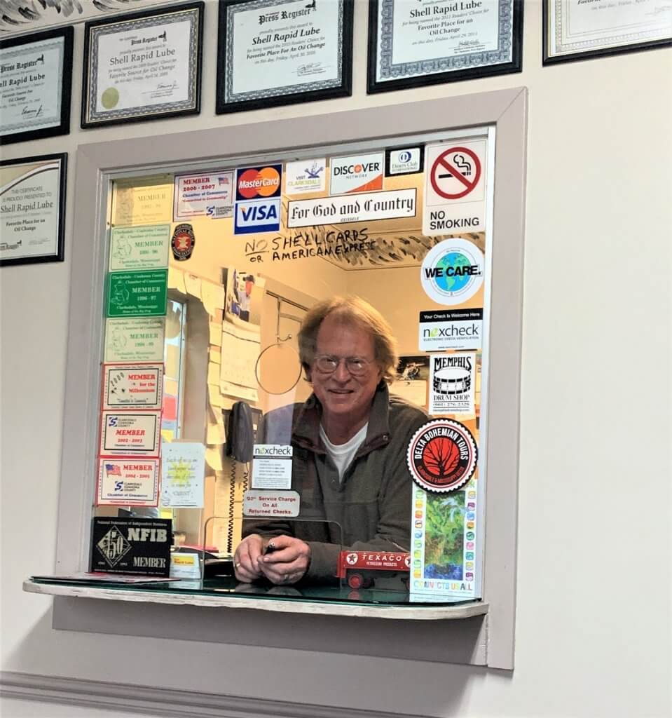 Man at reception window with stickers