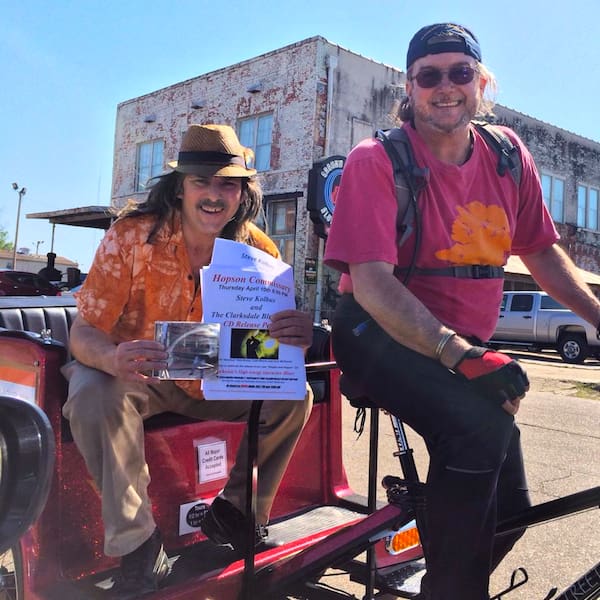 Men posing with flyer and CD.