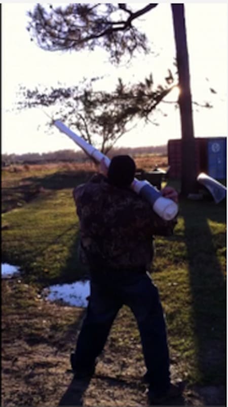 Individual with pipe under tree