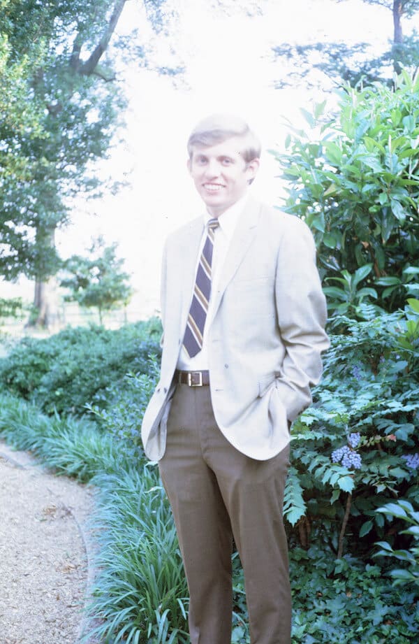 Smiling man in formal attire outdoors