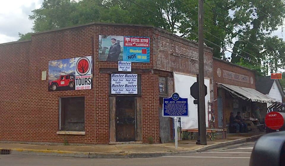 Old brick storefront with colorful advertisements