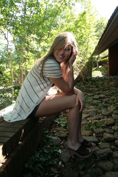 Woman smiling outdoors on a sunny day
