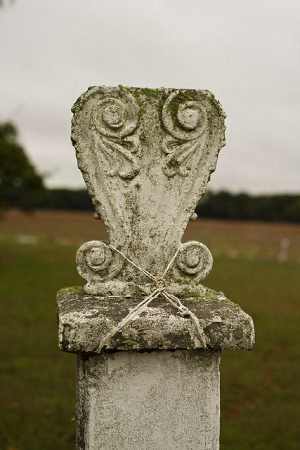 Rustic stone pillar in field