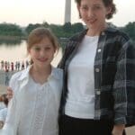 Two women standing in front of a monument.