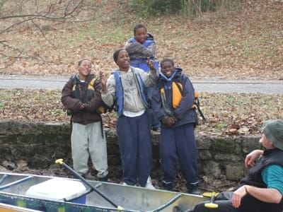 Kids posing beside a canoe trip