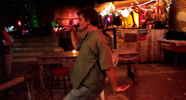 Man dancing in dimly lit bar