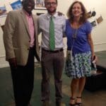 Three people smiling for a group photo.