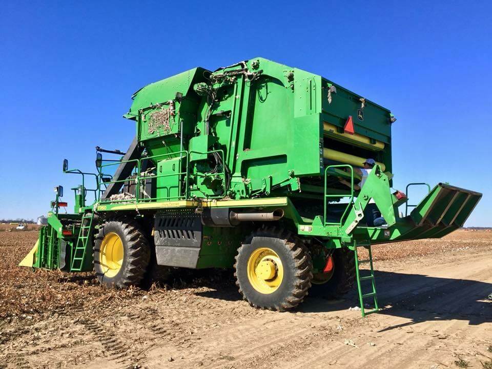 Green combine harvester in a field