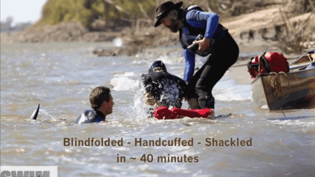 Jay Platt, former Marine, finishing his swim across the Mississippi River blindfolded, handcuffed and shackled.