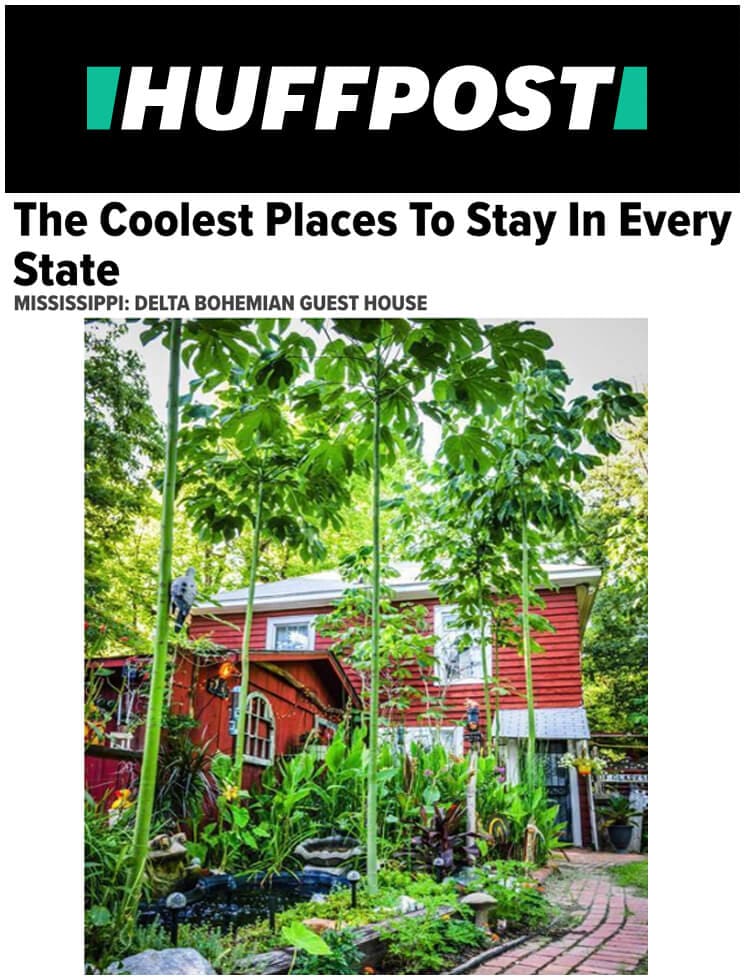 Red guest house with lush greenery