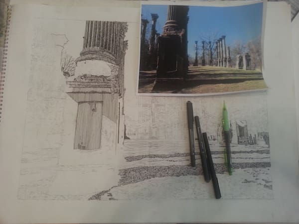 Art supplies on paper with column sketch