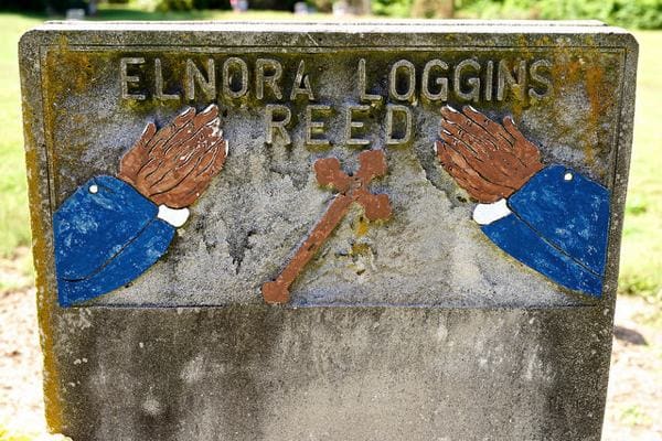 Memorial stone with engraved name and designs
