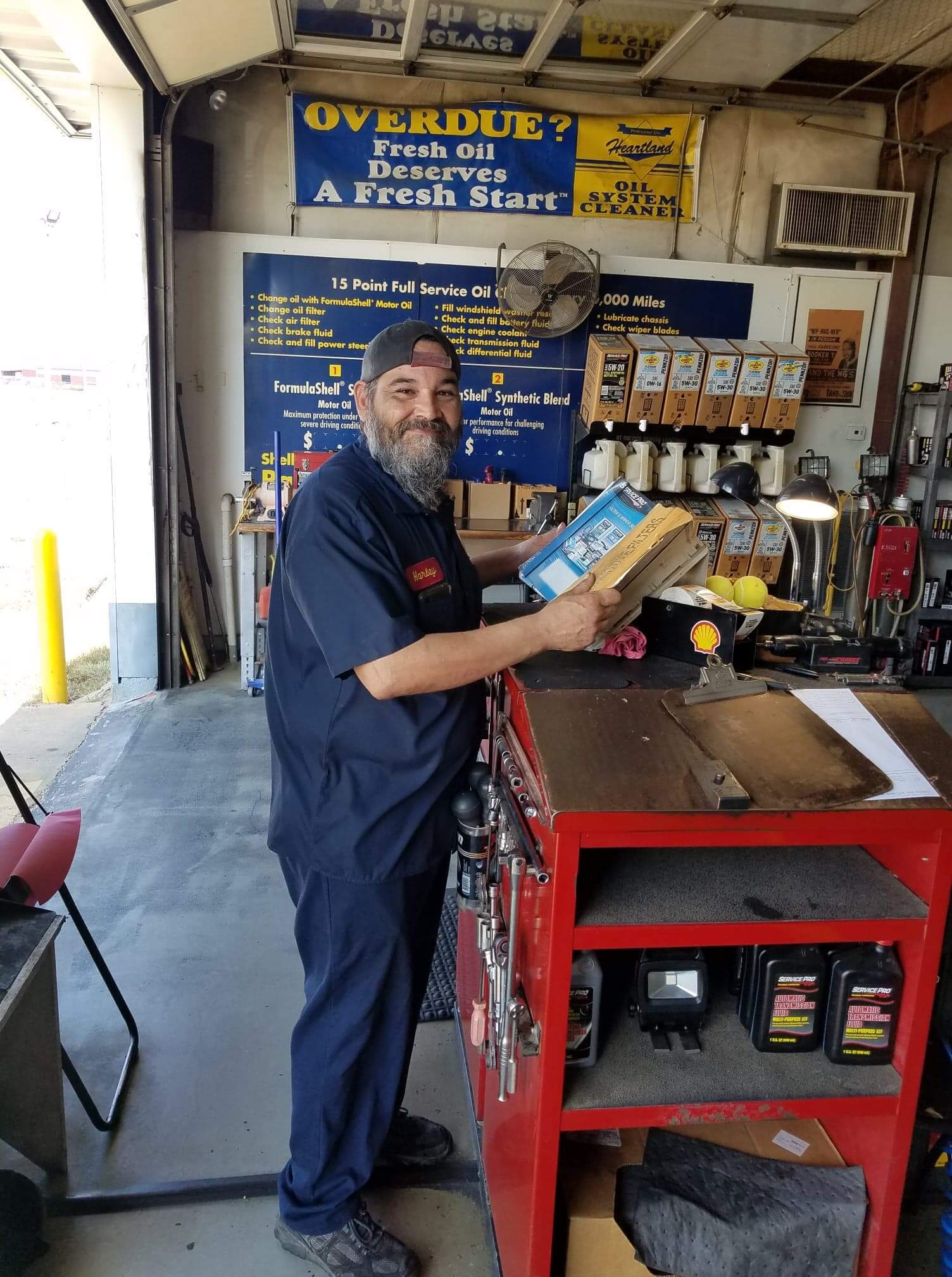 Bearded man smiling in auto shop