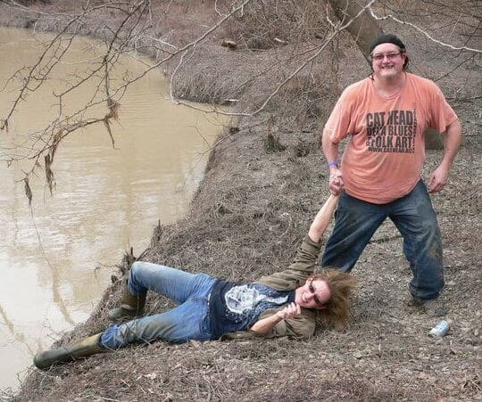 Friends having fun by the riverbank