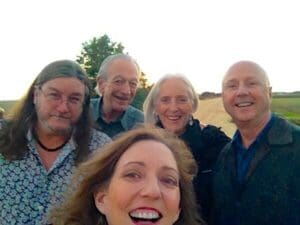 Group portrait of five smiling friends.