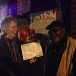 Two people holding a September calendar.