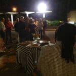 Group of people gather around a table.