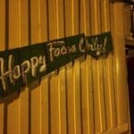 Green sign with white text: "Happy Faces Only!"