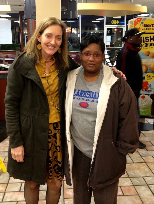 Two people posing in a fast food restaurant
