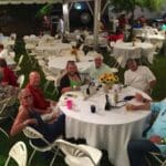 Group of people enjoying a meal outdoors.