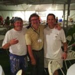 Three men smiling at a party.