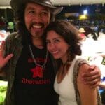 Man in hat with woman, animal liberation shirt.