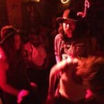 Group of people in a dimly lit bar.