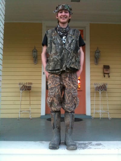 Person in camo outfit on porch