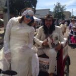 Bride and groom with a white dog.