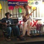 Two men playing music on stage.