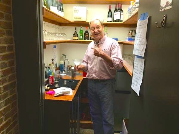 Man enjoying drink in cozy bar nook