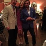 Three people at a formal event.