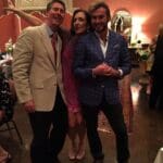 Three people smiling at a party.