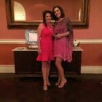 Two women in dresses at a party.