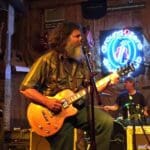 Man playing guitar at Ground Zero Blues Club.