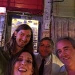 Three men smiling for a photo.