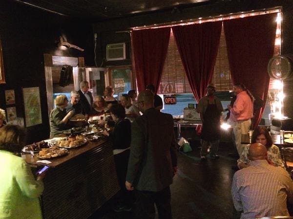 Indoor party with buffet and guests mingling