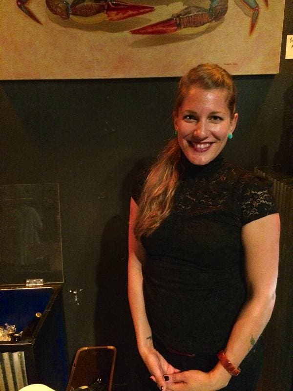 Smiling woman in black dress indoors