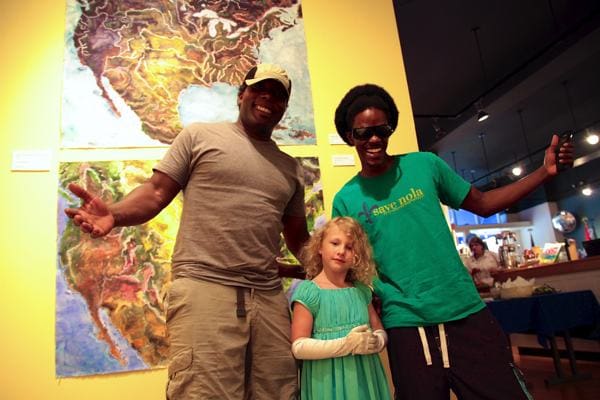 Mark River Peoples, Emma Lou Ruskey and Chris with John Ruskey paintings in the background.