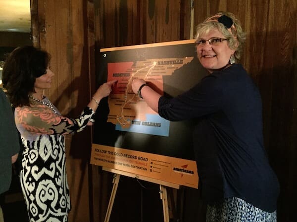 Smiling women discussing a map exhibit