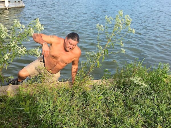 Man climbing out of water